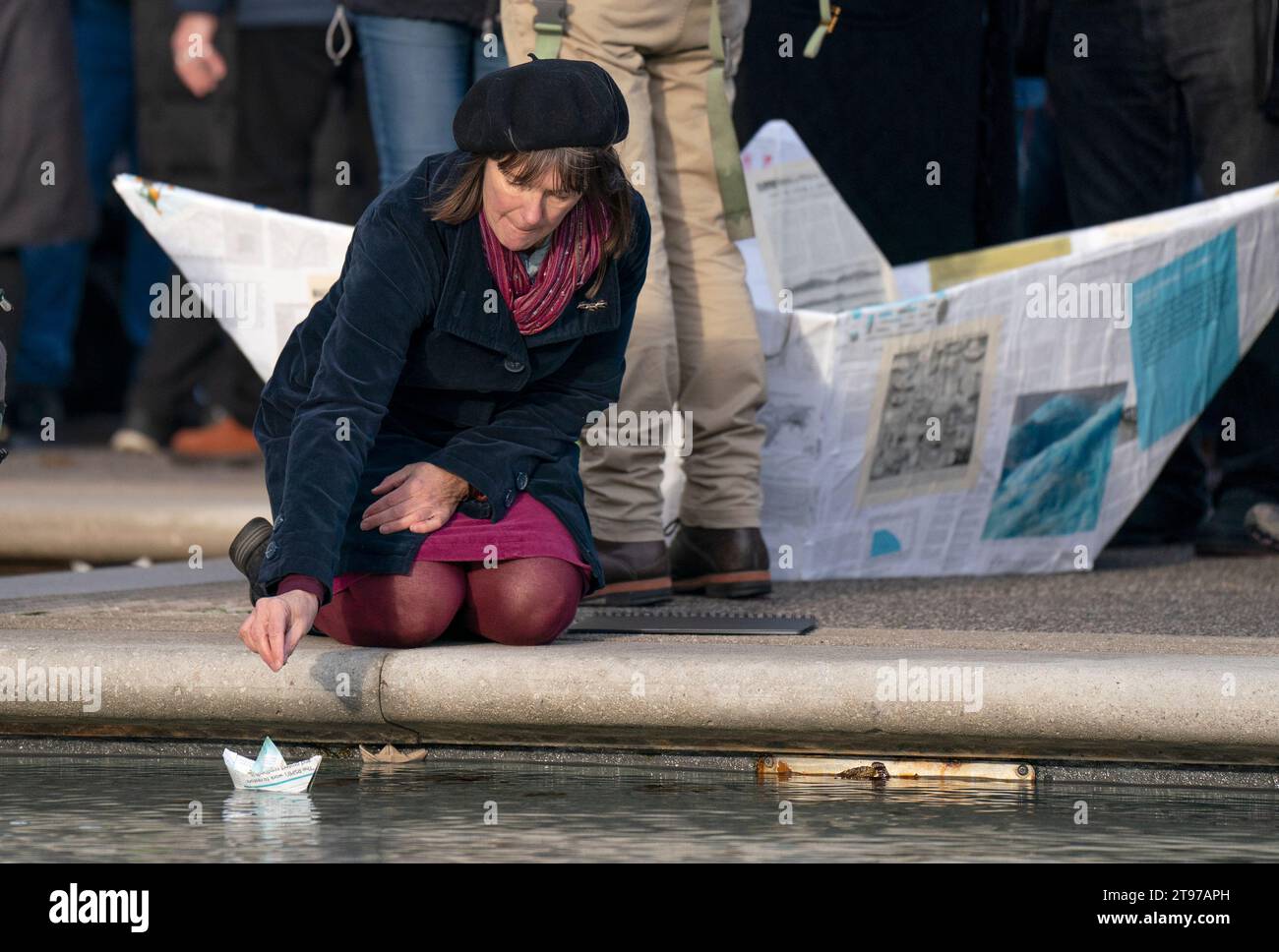 Scotland's Makar (National Poet for Scotland) Kathleen Jamie places a paper boat in the pools outside the Scottish Parliament in Edinburgh, during an event organised by Scottish nature writers' collective Paperboats, to demand cross-party support for action on climate. Picture date: Thursday November 23, 2023. Stock Photo
