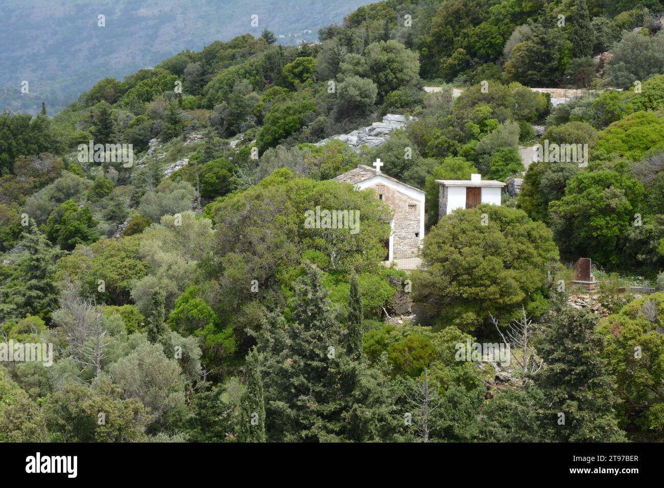 A small Orthodox Christian church or chapel located in the hills and forest above the town of Evdilos, on the Greek Island of Ikaria, Greece. Stock Photo