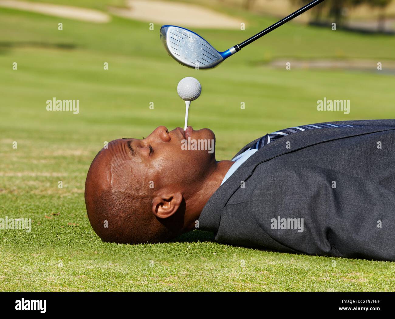 Black man, face and lying on golf course with tee in mouth for hole in