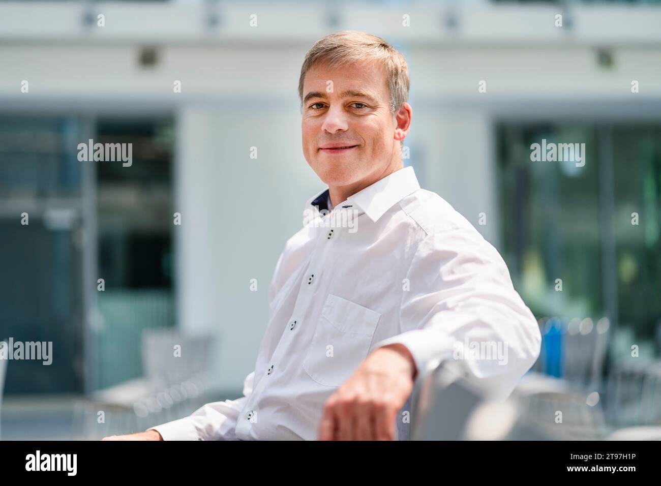 Confident businessman sitting in company auditory Stock Photo