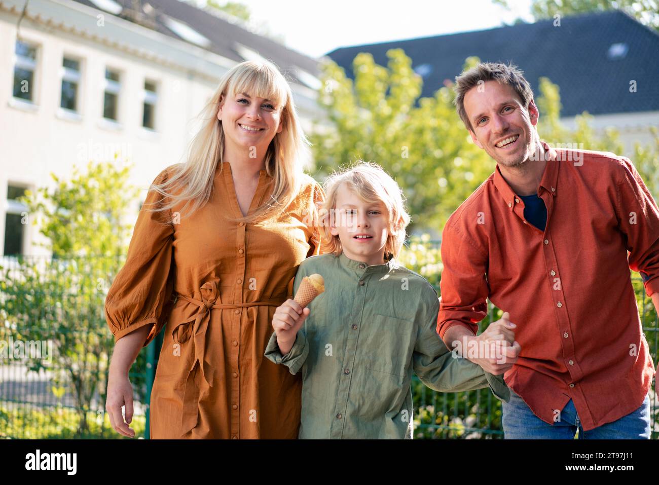 Happy parents with son holding ice cream cone on sunny day Stock Photo