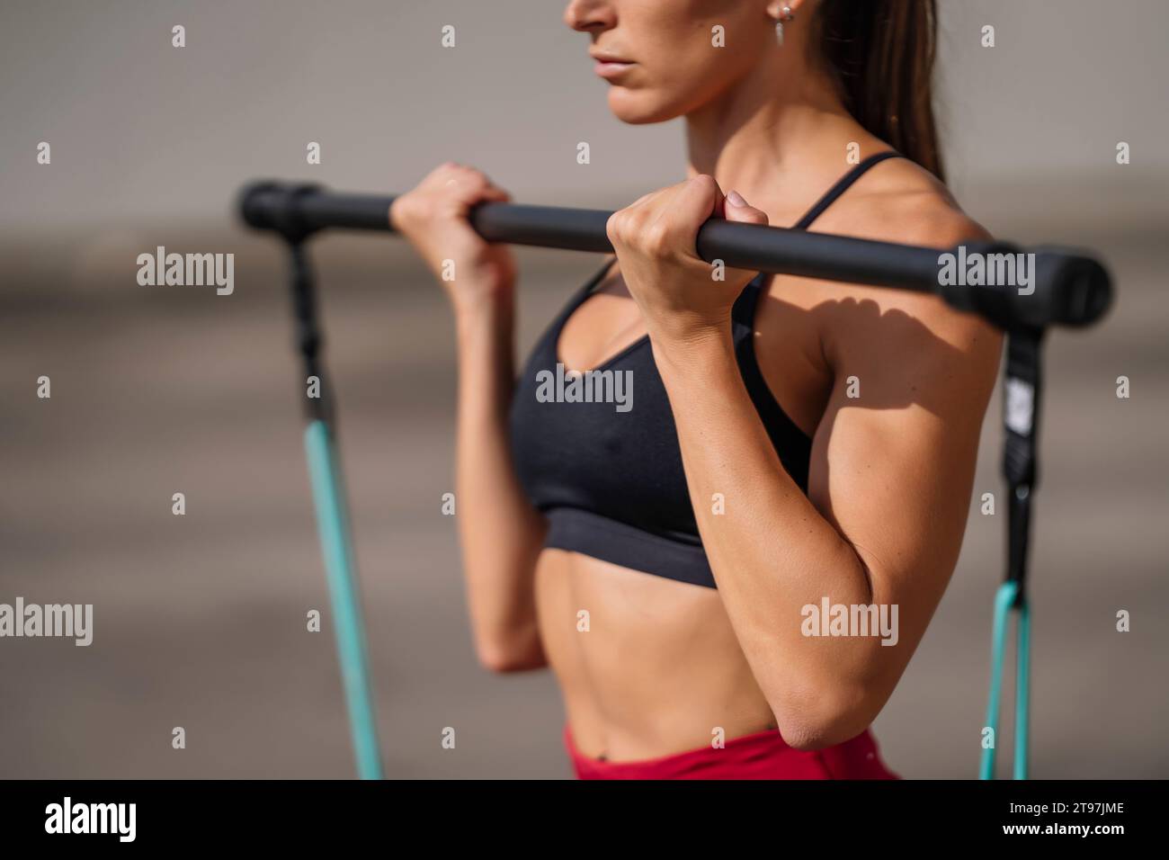 Active woman doing strength training using resistance band Stock Photo