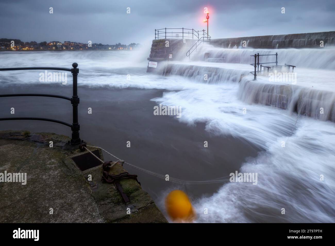 UK, Scotland, North Berwick, Long exposure of waves splashing against harbor walls during Storm Babet Stock Photo