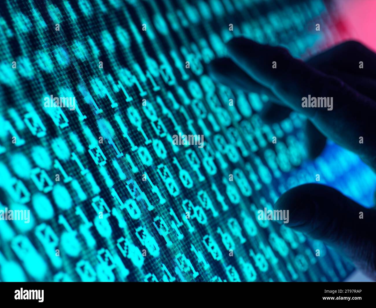 Hand of man touching screen displaying binary code Stock Photo