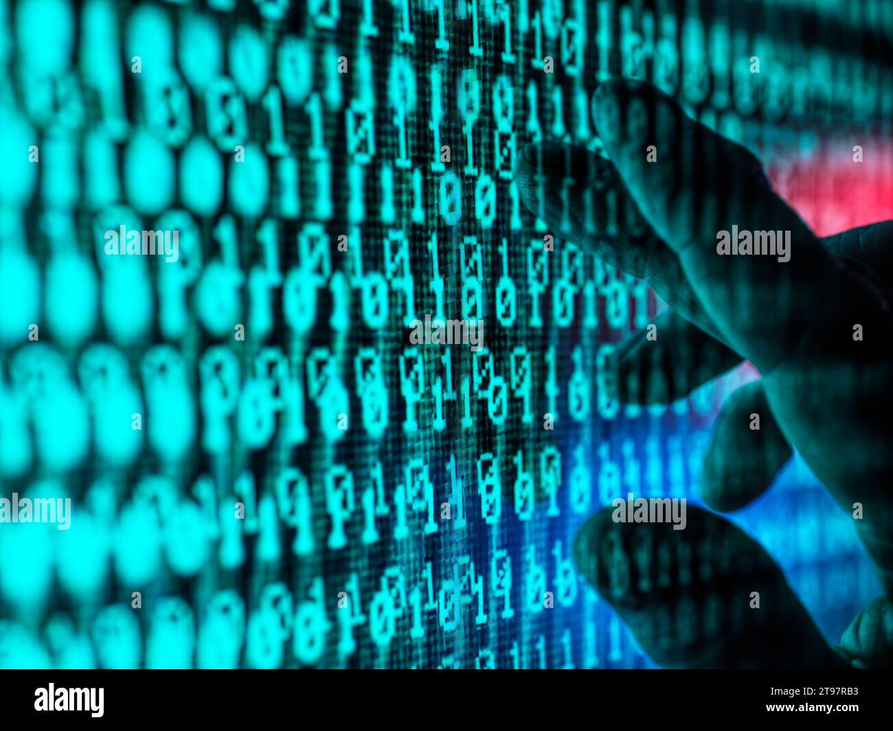 Hand of man touching screen displaying binary code Stock Photo