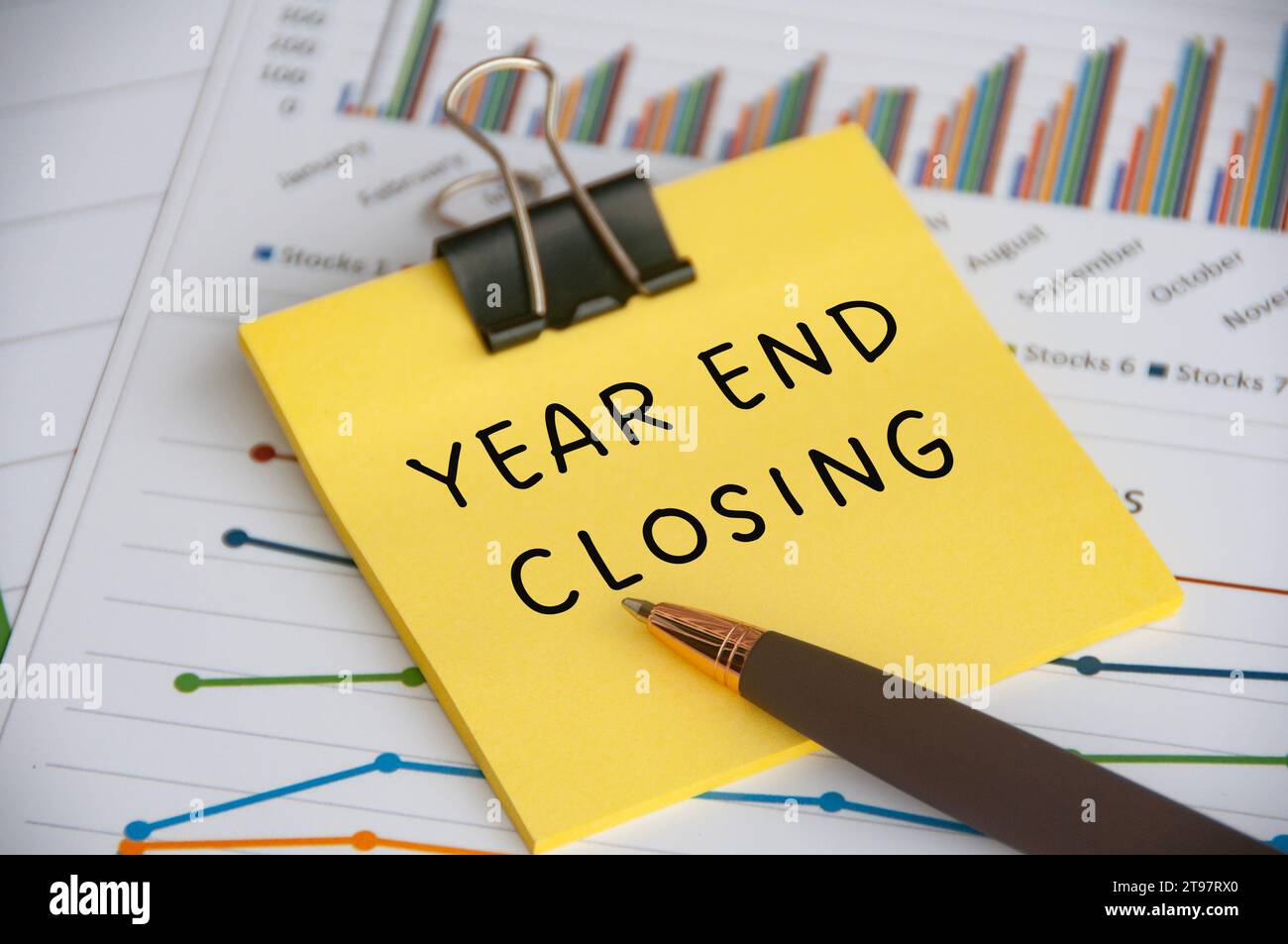 Year End Closing text on sticky note with statistic and graph