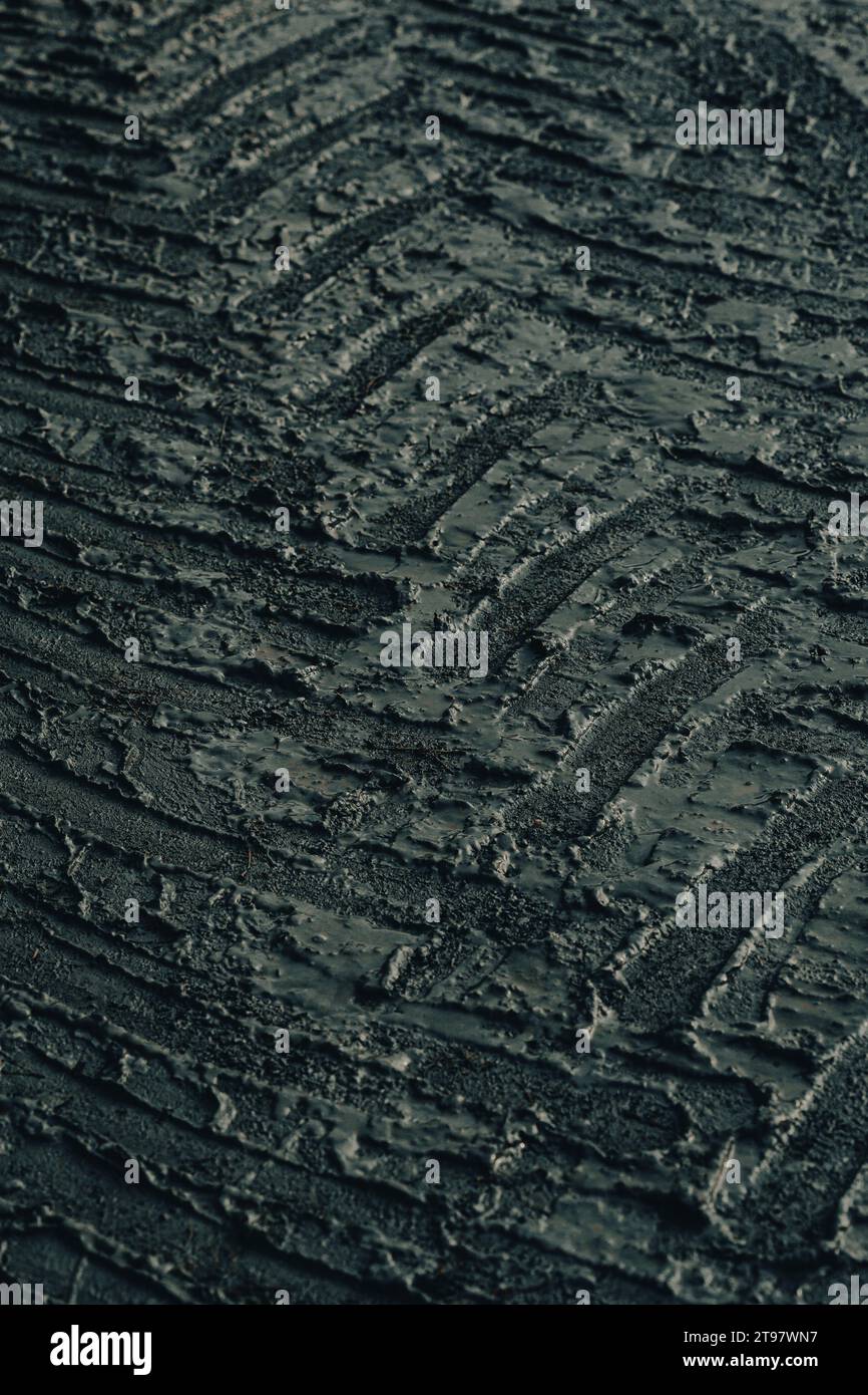 dark muddy road background with tire traces, dirty ground Stock Photo