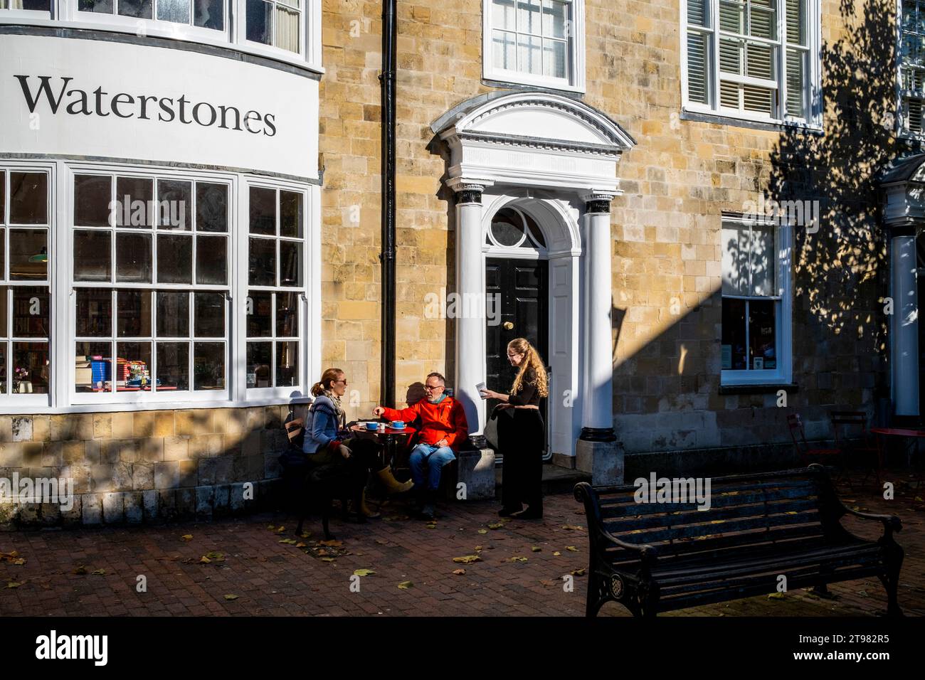 Two People Sitting Outside A Cafe On A Sunny Day, High Street, Lewes, East Sussex, UK Stock Photo