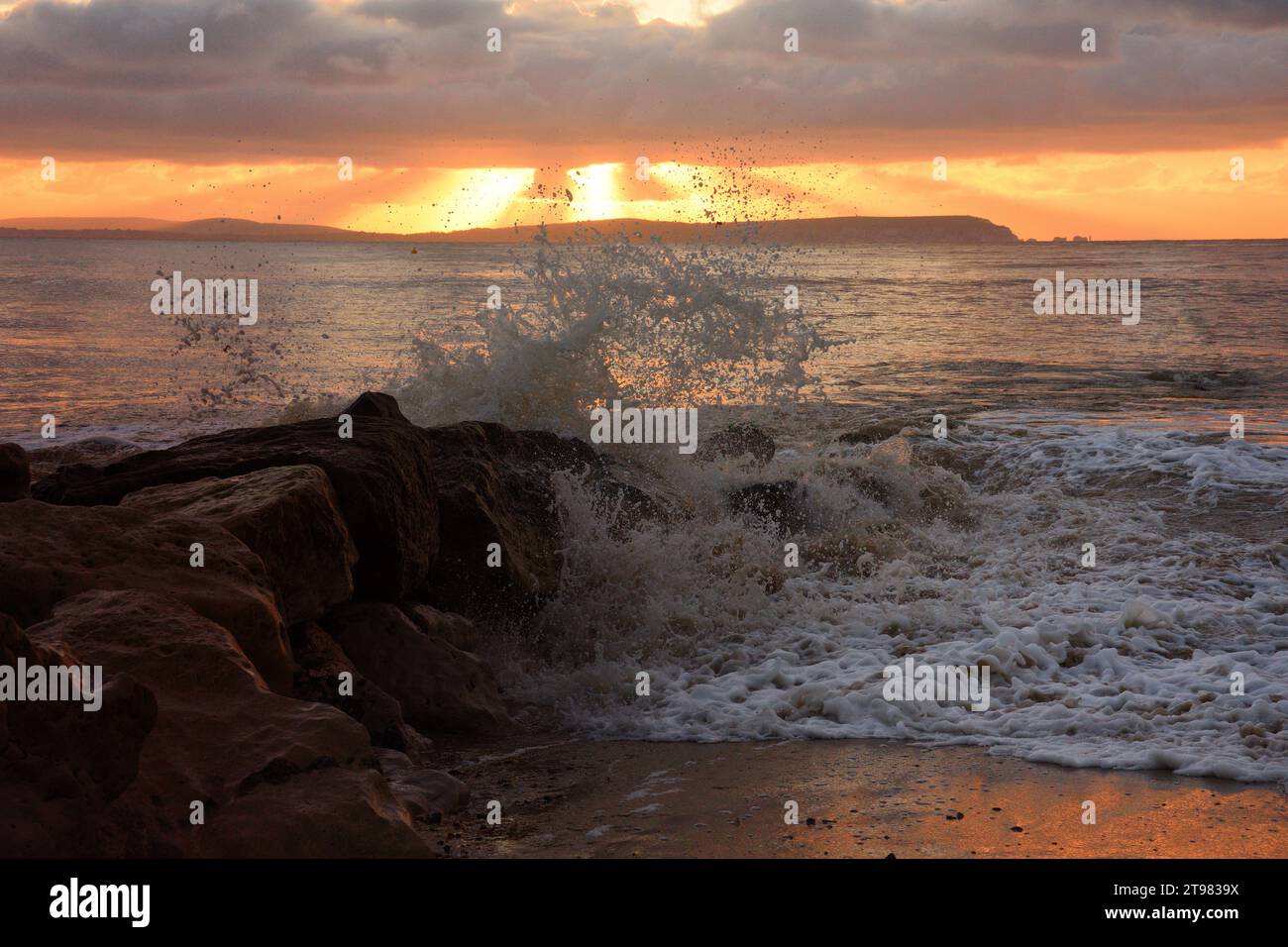 Sunrise over Avon beach in Christchurch Dorset with beaking waves and