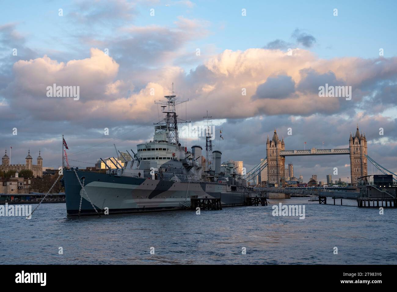 HMS Belfast on the River Thames looking towards Tower Bridge on 15th November 2023 in London, United Kingdom. HMS Belfast is a museum ship, permanently moored in London on the River Thames. She was originally a Royal Navy light cruiser and served during the Second World War and Korean War. Stock Photo