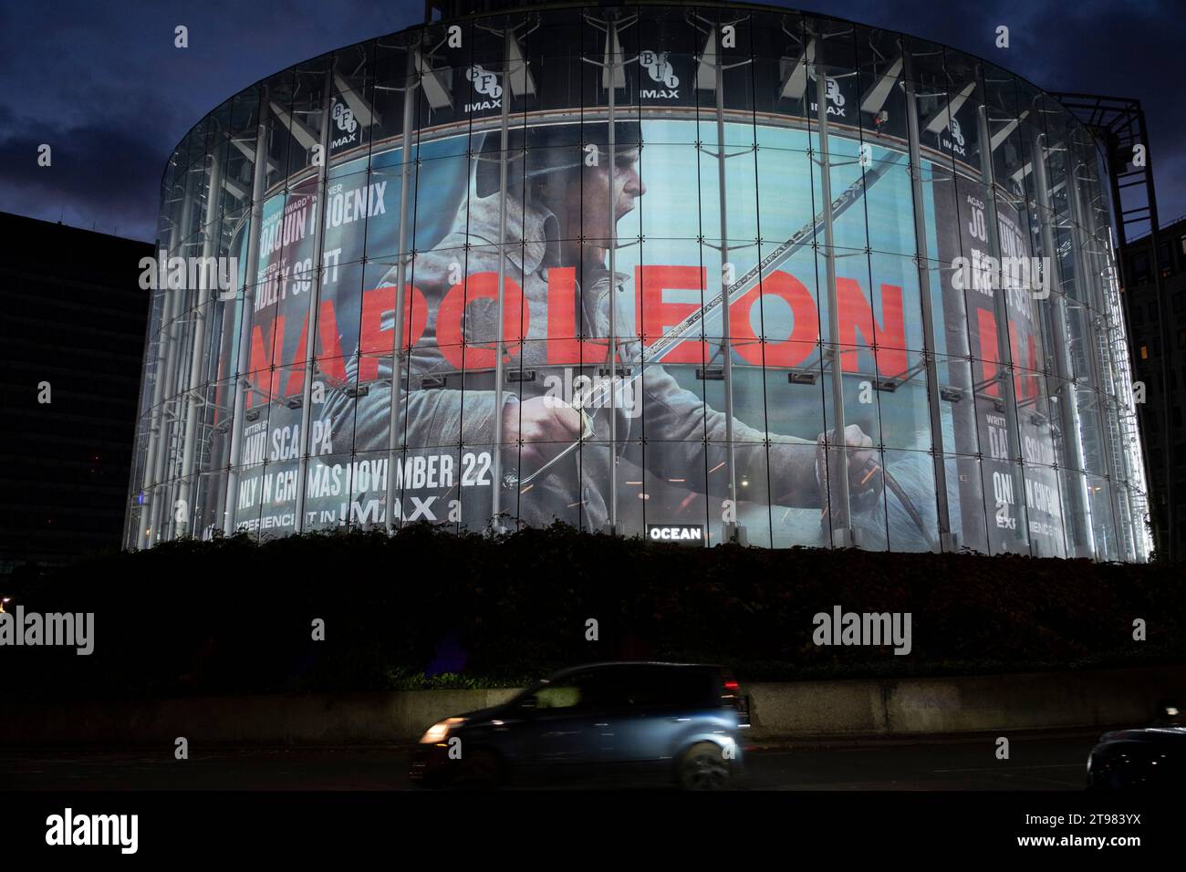 Night traffic passes a large scale promotional advertisement for the new Ridley Scott film Napoleon on the circular exterior of the IMAX cinema at Waterloo on 15th November 2023 in London, United Kingdom. Stock Photo