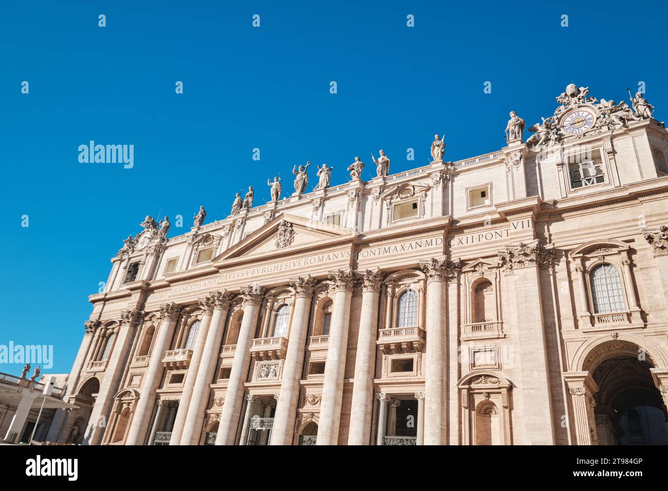 Rome, Italy - October 29 2023: View of Saint Peter's Basilica and it's facade detail with Corinthian order columns and  blue sky Stock Photo