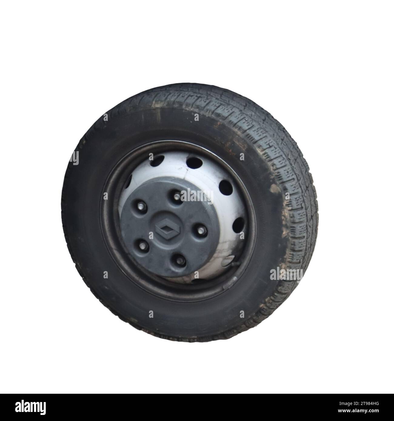 A black tire lying upsidedown on a flat surface, with a flat tire