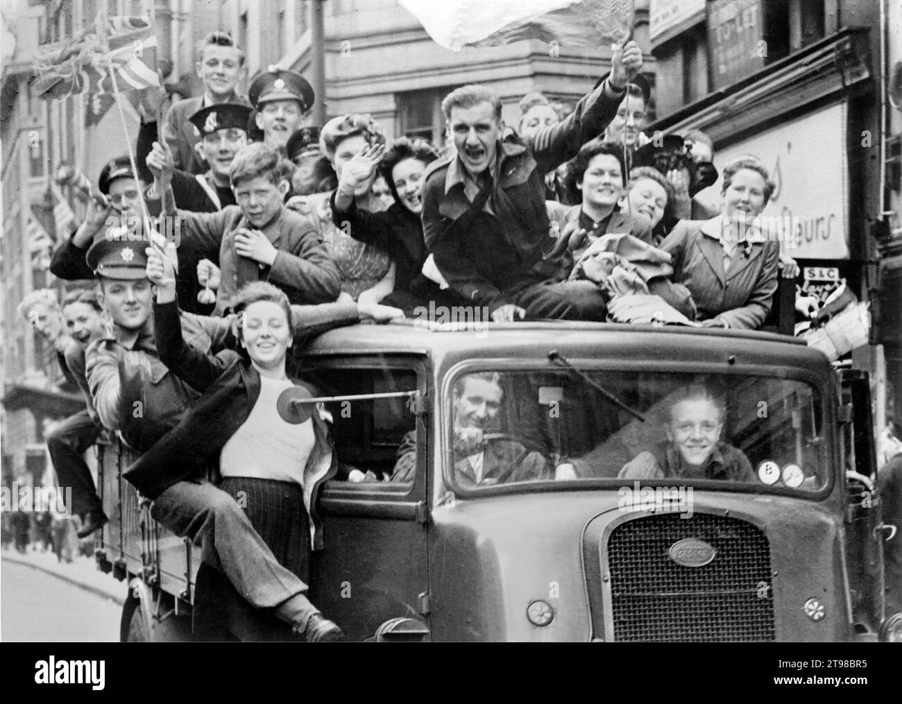 VE Day. Crowd of people on a truck in the Strand, London on V-E Day after the announcement of the German surrender, 8th May 1945 Stock Photo