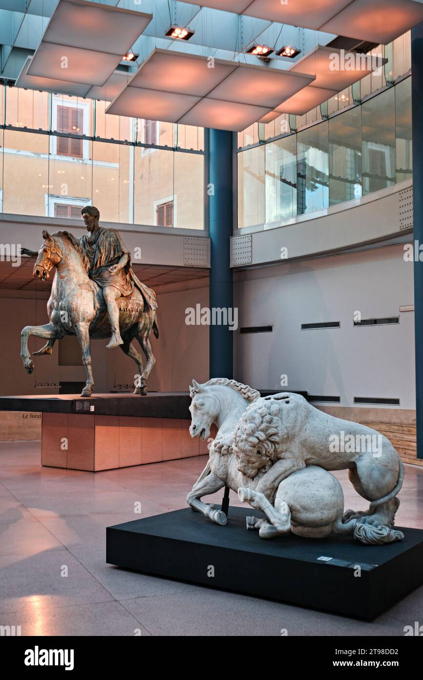Rome, Italy - October 29 2023: Lion Attacking a Horse statue and Bronze Equestrian Statue of Marcus Aurelius in Capitoline Museums Stock Photo