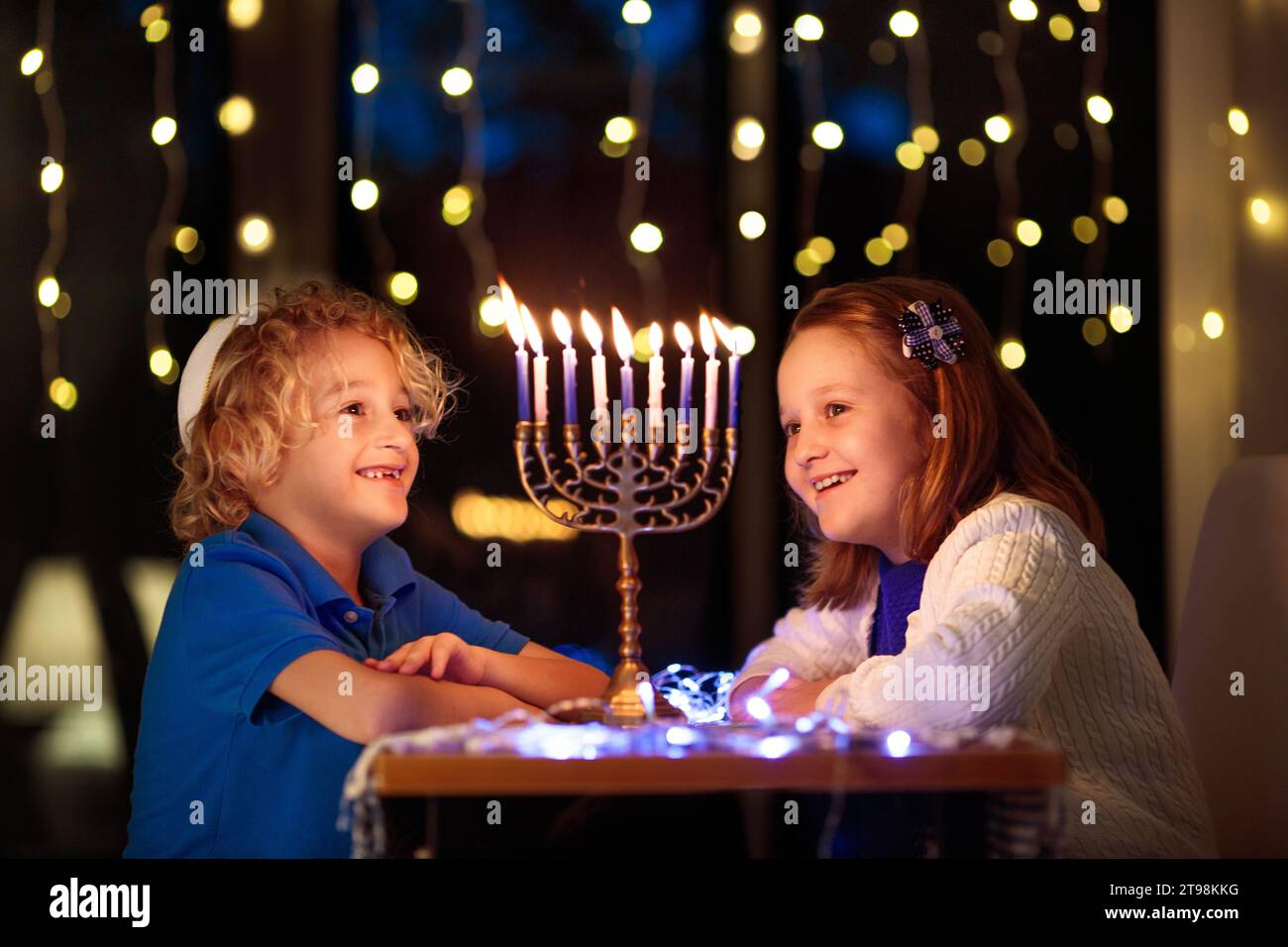Kids celebrating Hanukkah. Jewish festival of lights. Children lighting