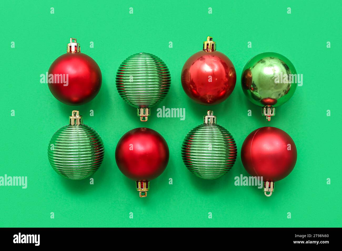Composition with green and red Christmas balls on green background ...