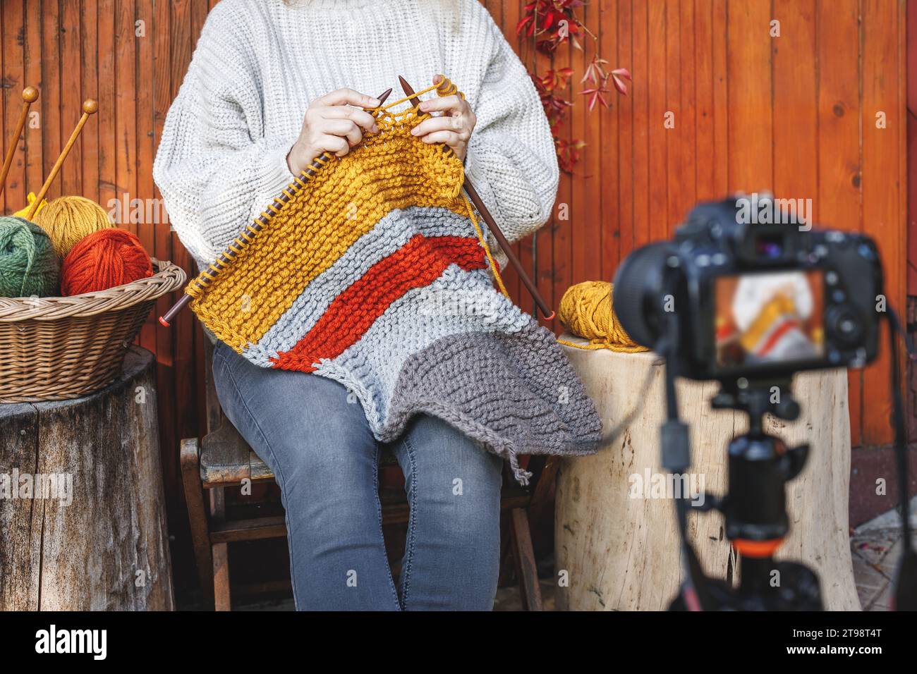 Woman vlogging her knitting technique and skill. Creative female vlogger live streaming on social media Stock Photo