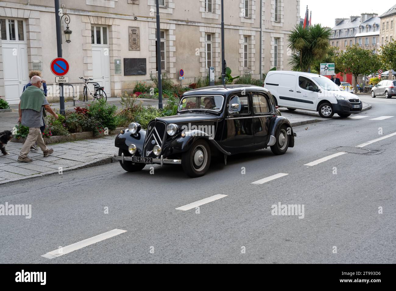 close-up of a pristine black Citroen Traction Avant motor car driving along the high street Stock Photo