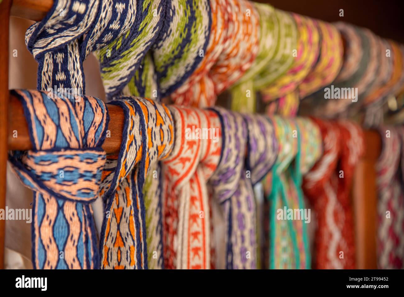 Many colorful belts with patterns. Folk art, handmade, Knitting of a traditional ethnic latvian folk belt Stock Photo