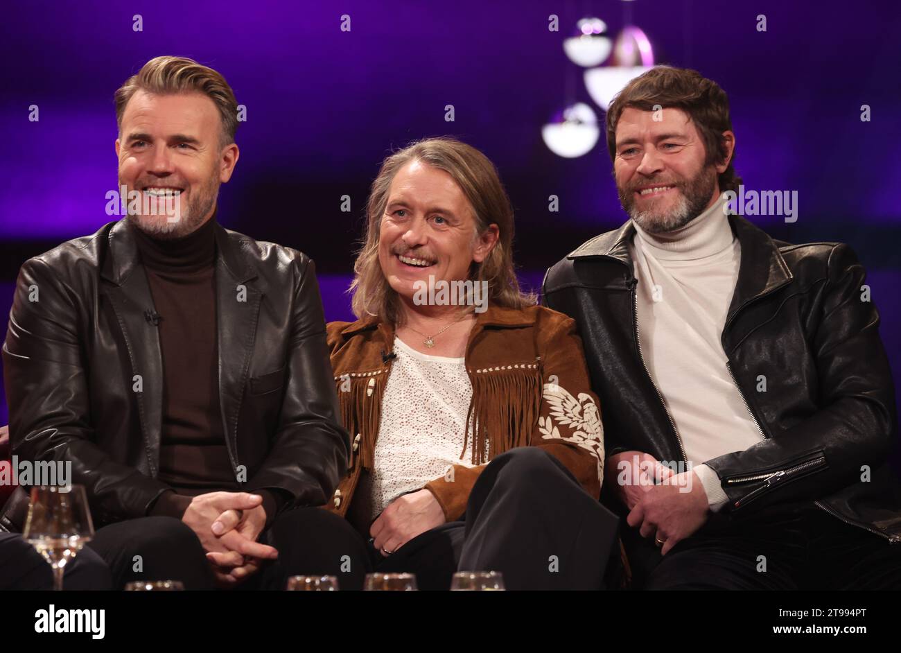 EDITORIAL USE ONLY (left to right) Gary Barlow, Mark Owen and Howard Donald of Take That during filming for the Graham Norton Show at BBC Studioworks 6 Television Centre, Wood Lane, London, to be aired on BBC One on Friday evening. Picture date: Thursday November 23, 2023. Stock Photo