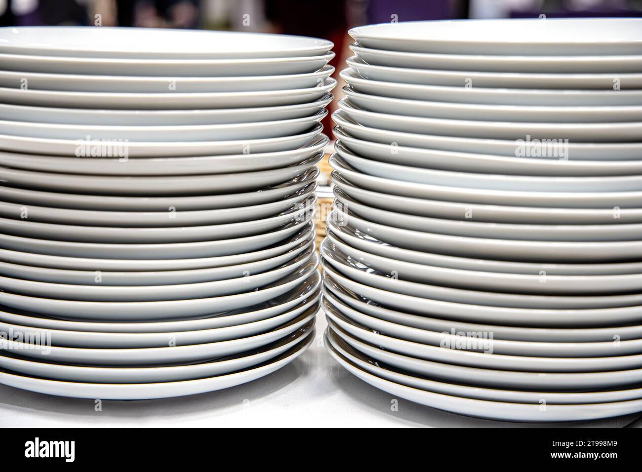 Stack of white plates on a shelf in a store or restaurant Stock Photo ...