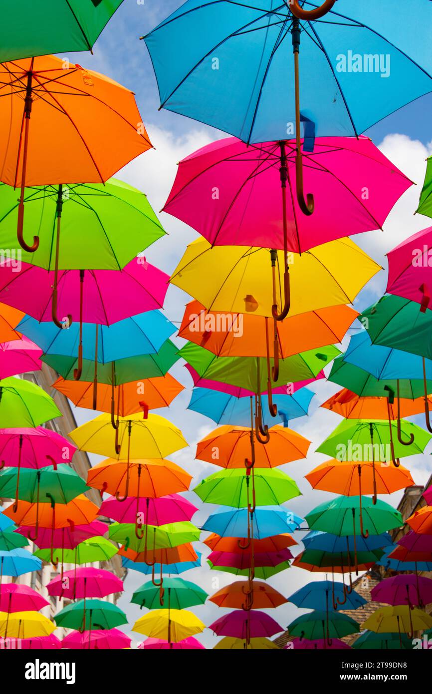 Multicolored umbrellas against a blue sky Stock Photo