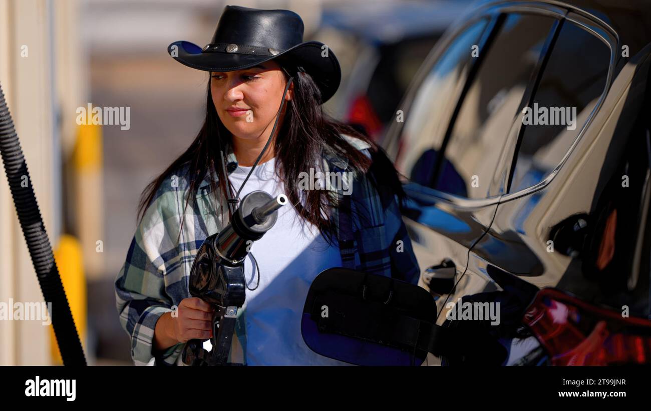 Young woman filling up her SUV car at a gas station Stock Photo - Alamy