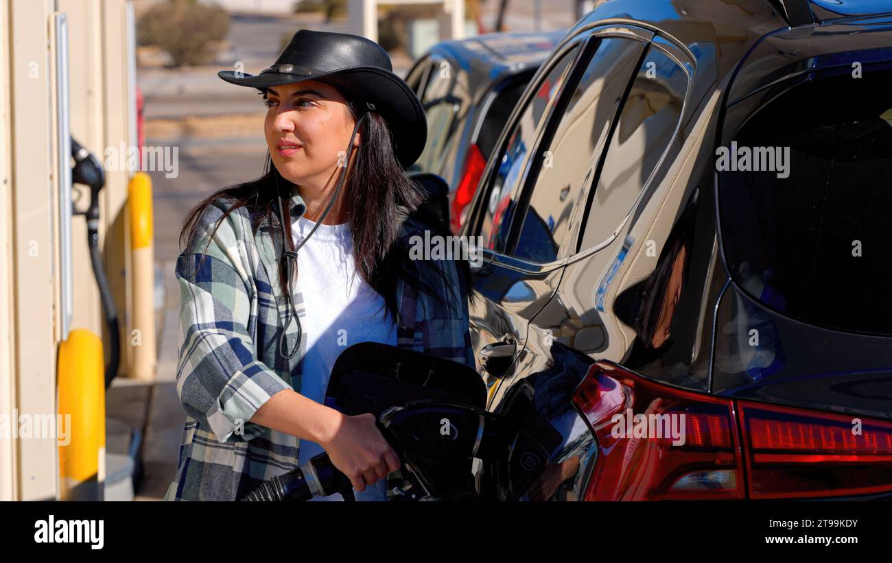 Young woman filling up her SUV car at a gas station Stock Photo - Alamy