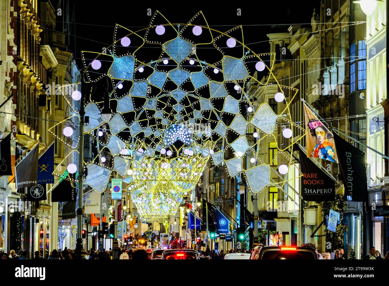 London, UK. 23rd November, 2023. Crown and tiara-inspired Christmas light display. Visitors and shoppers admire the shop displays in New Bond Street and Old Bond Street. Credit: Eleventh Hour Photography/Alamy Live News Stock Photo