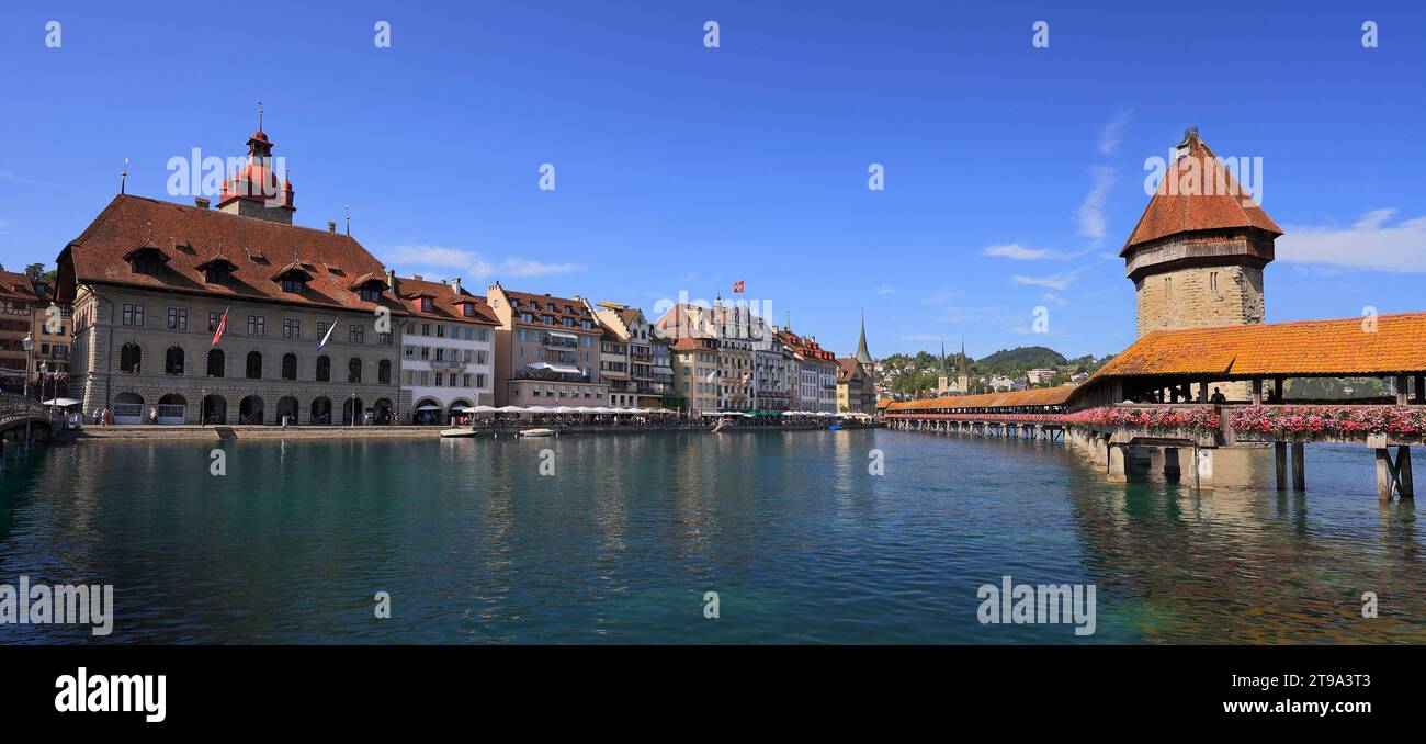 Panoramic view towards Chapel Bridge (Kapellbruecke) together with the octagonal tall tower (Wasserturm) in Lucerne, Switzerland Stock Photo