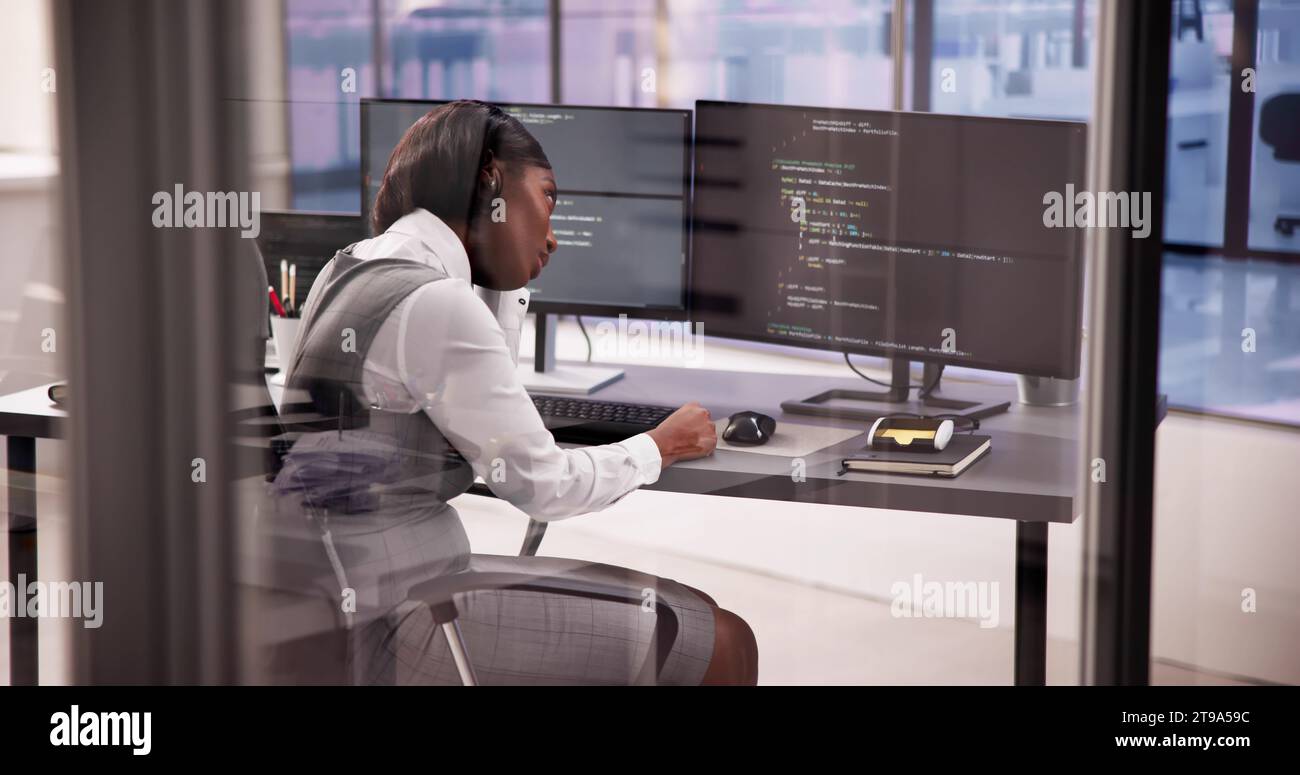 Business Engineer Analyzing Broken Code on Computer Screen Stock Photo