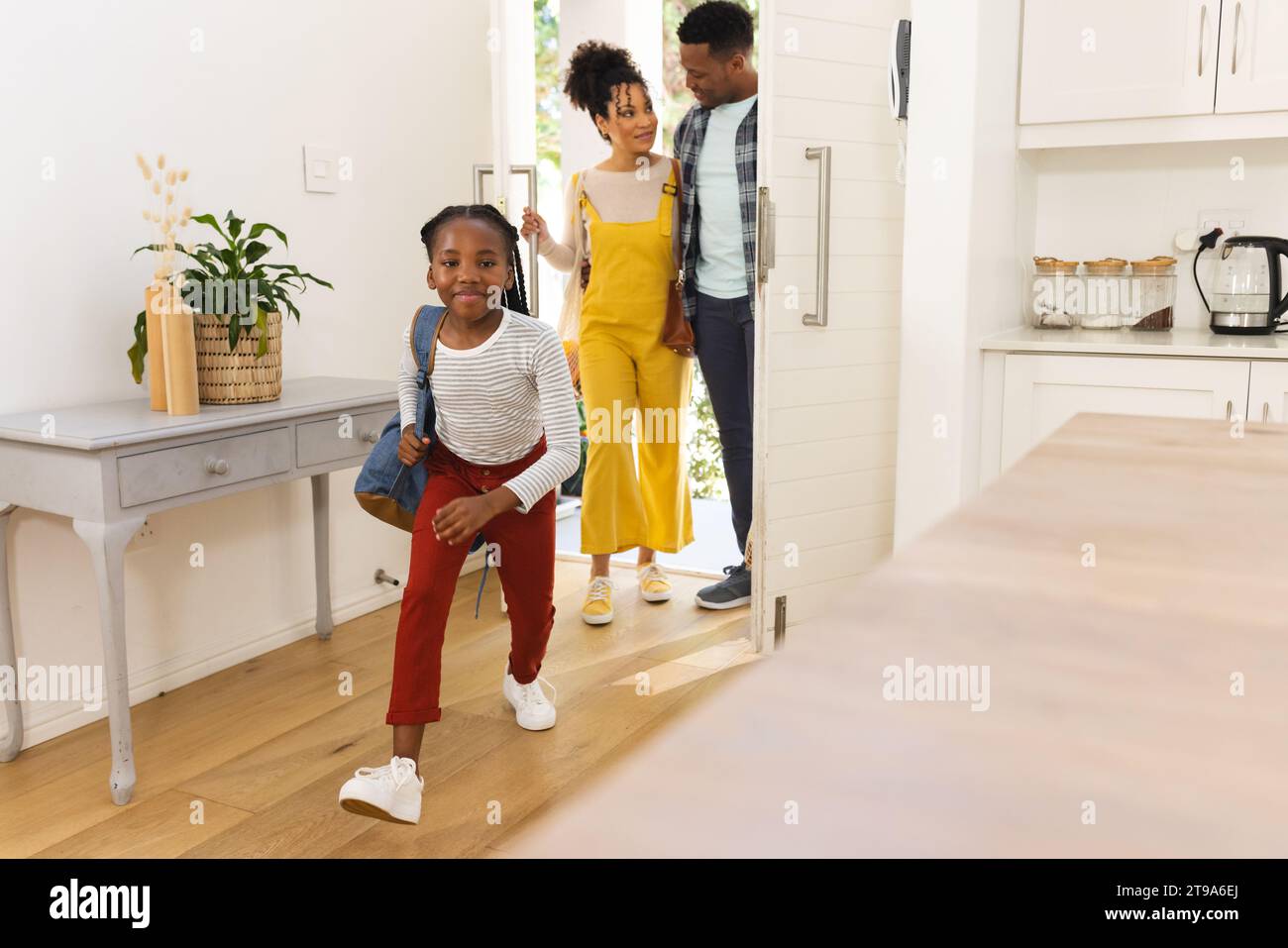 Happy african american family coming home, copy space. Expression, togetherness, parenthood, childhood and domestic life, unaltered. Stock Photo