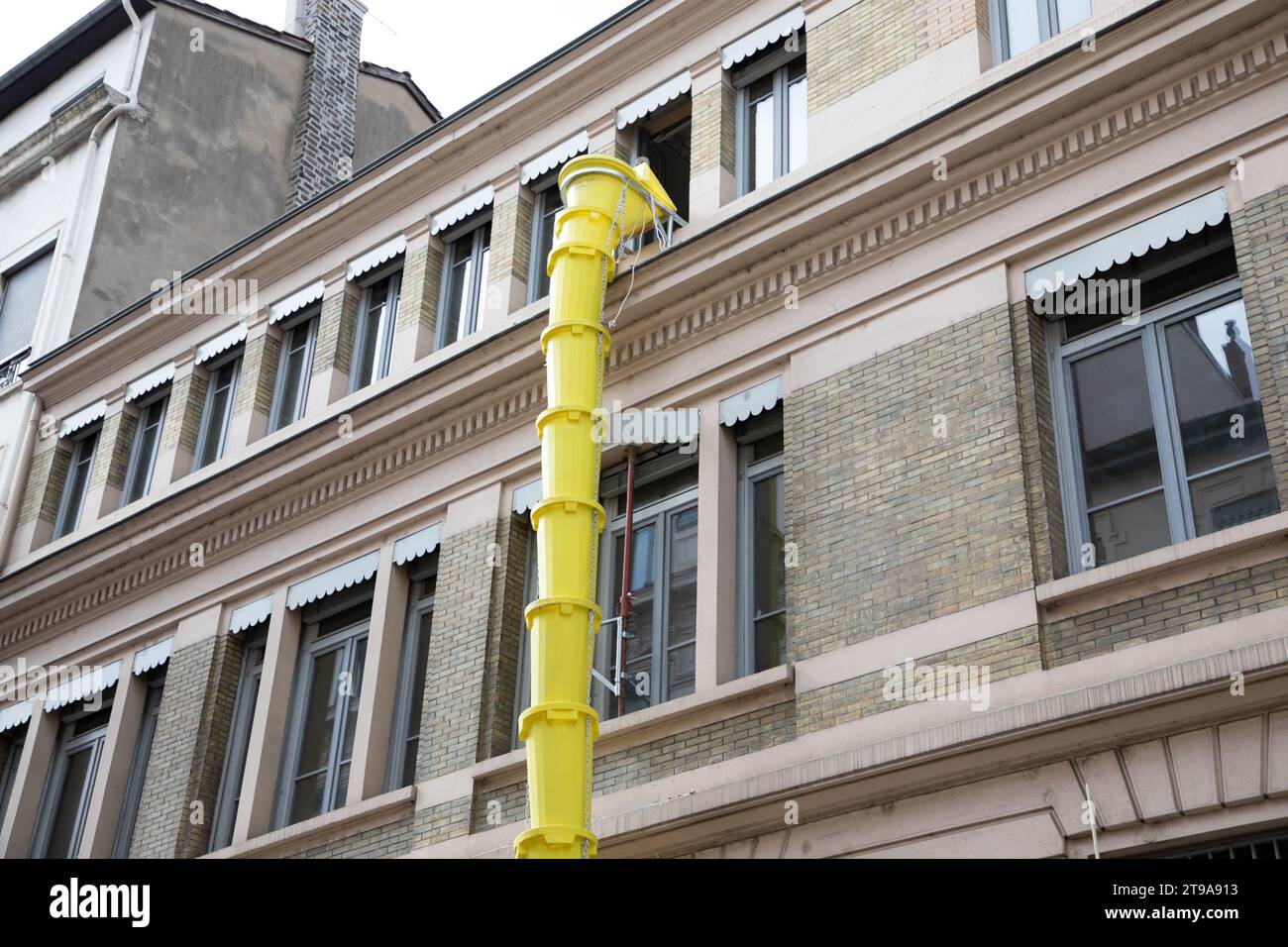 plastic slide chute yellow for rubble debris removal on building facade