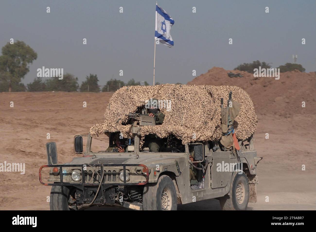 An Israeli military vehicle on its way to Gaza amid ongoing battles between Israel and Hamas on November 23, 2023 in Southern Israel. More than a month after Hamas's Oct. 7 attacks, the country's military has continued its sustained bombardment of the Gaza Strip and launched a ground invasion to vanquish the militant group that governs the Palestinian territory. Stock Photo