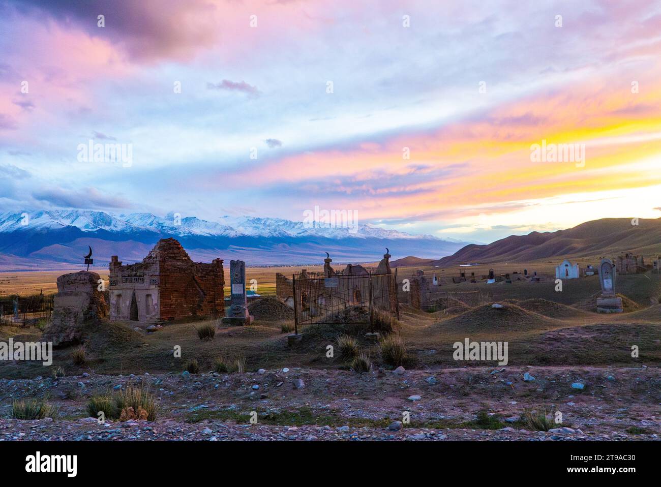 Traditional Muslim cemetery at the outskirts of a village in Kyrgyzstan Stock Photo
