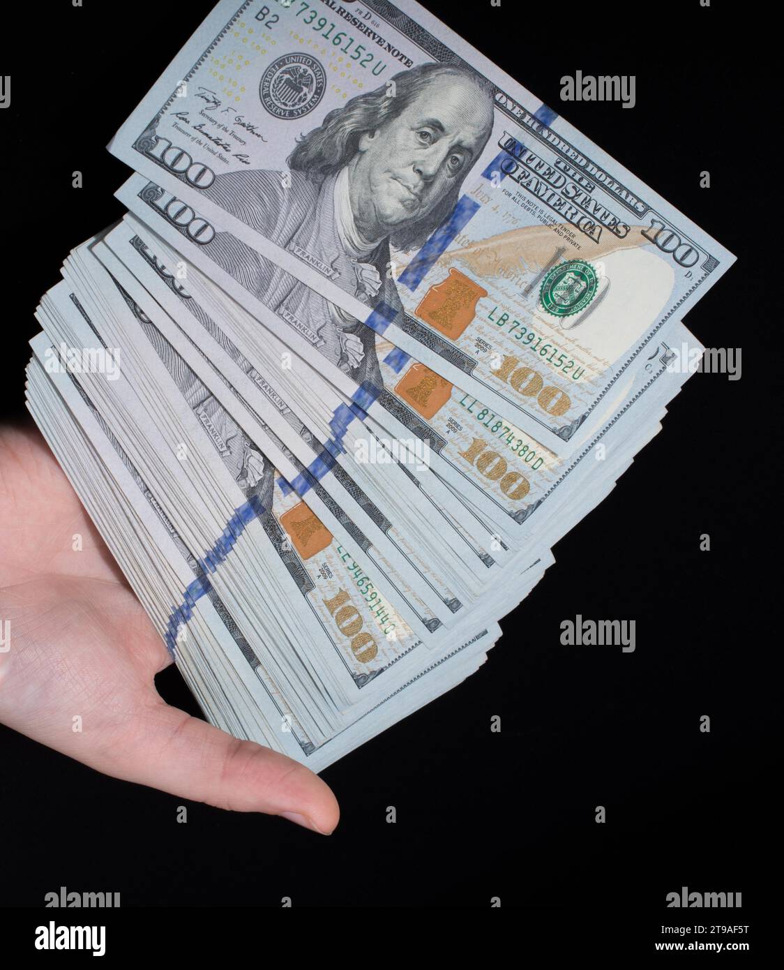 Hand holding American dollar banknotes isolated on white background ...