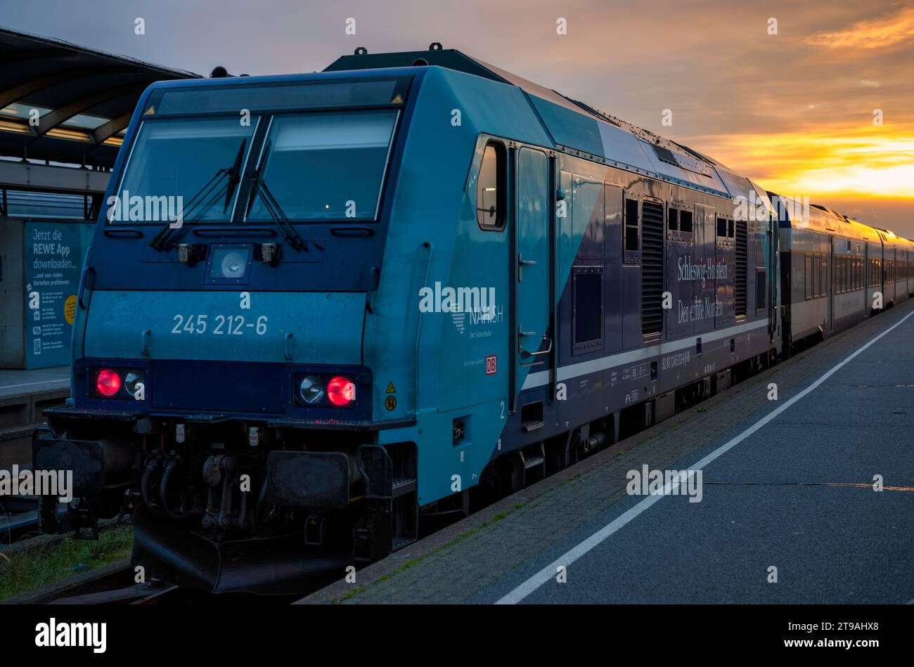 Diesel locomotive class 245, regional express RE standing at the platform, track, Westerland station, sunrise, North Sea island Sylt, North Frisia Stock Photo