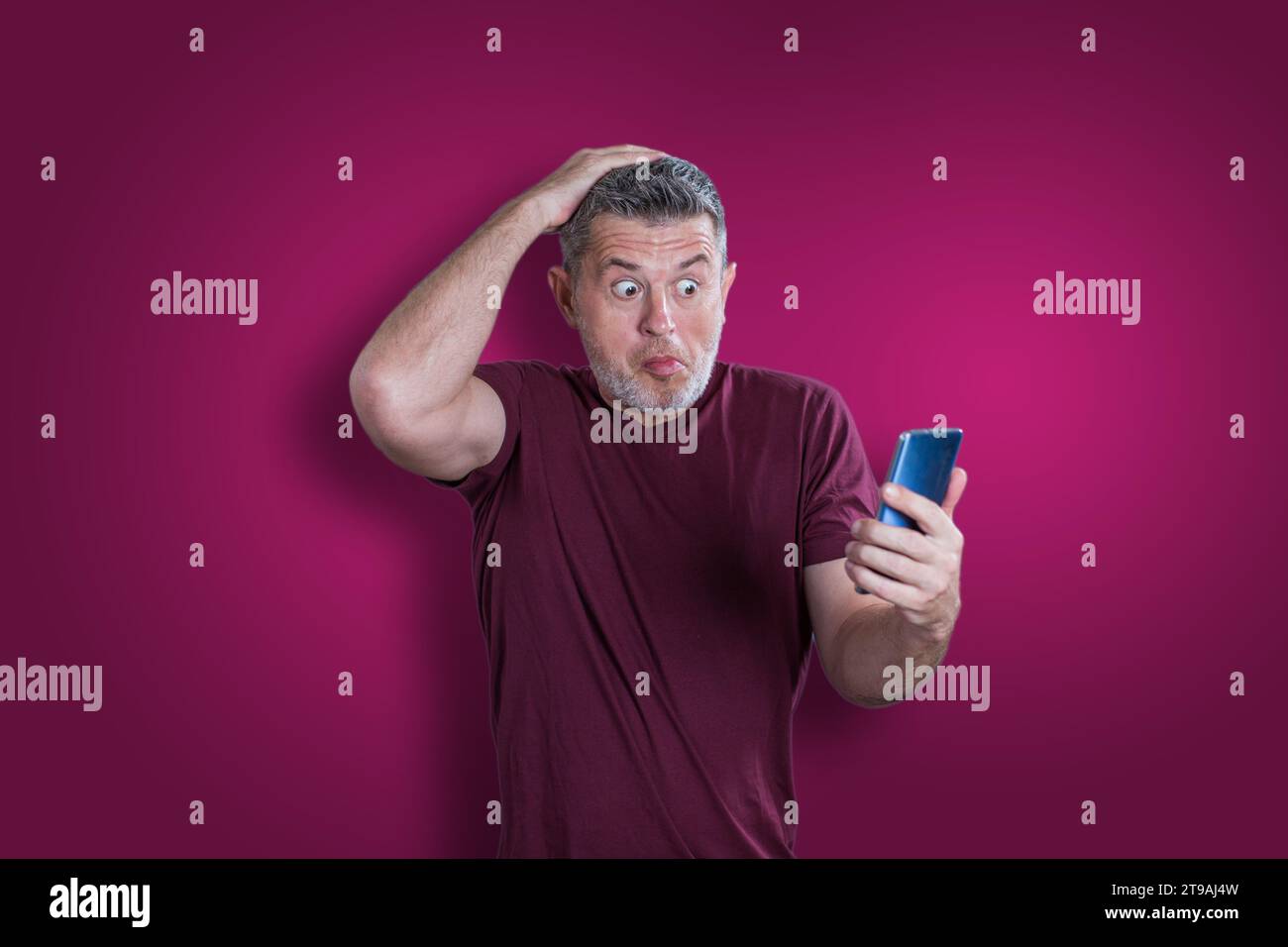 Confused serious man using mobile phone. Emotion concept Stock Photo