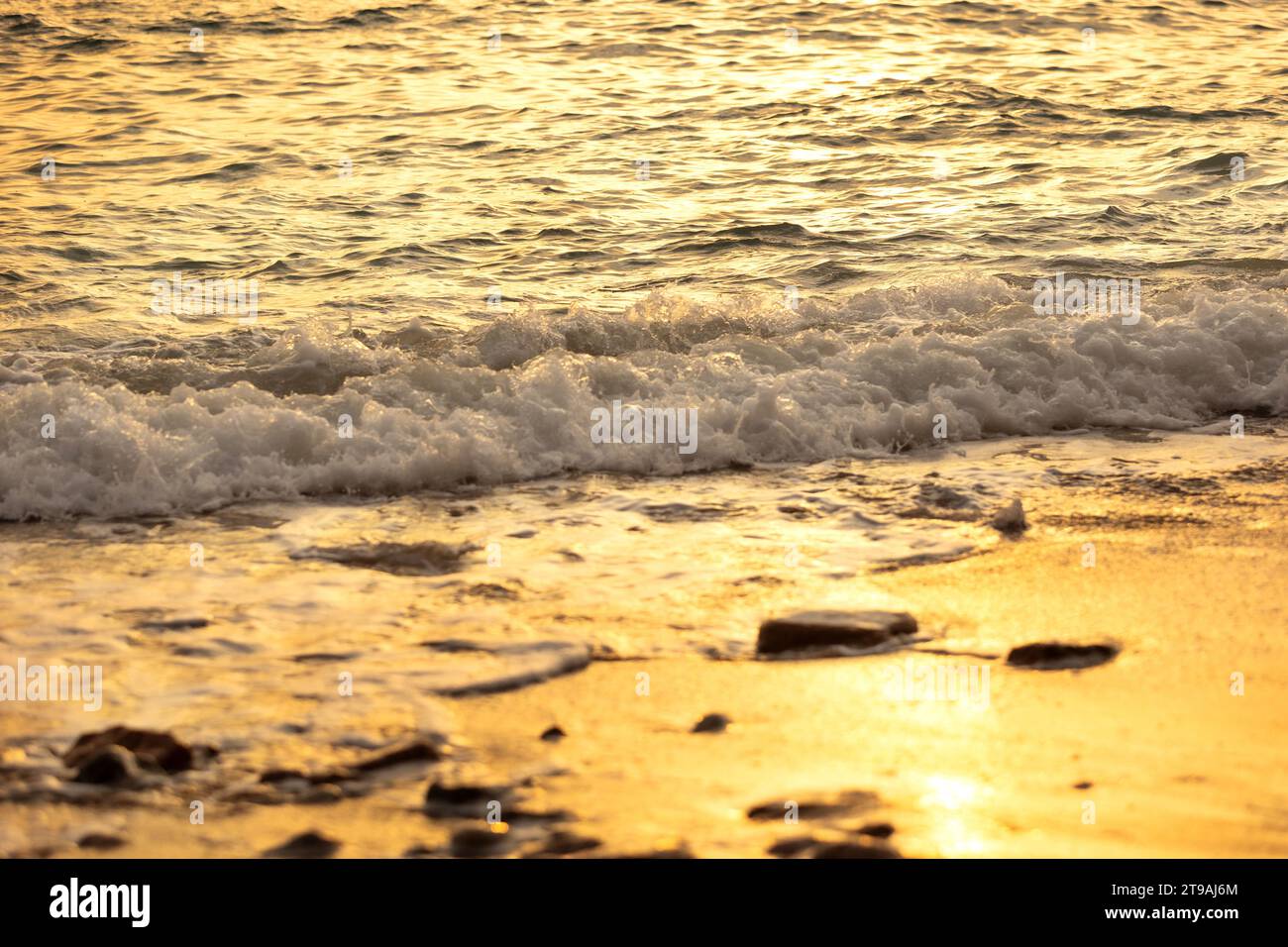 Wave gold splash and sandy beach, sun reflection, sunset sea travel nature summer background Stock Photo