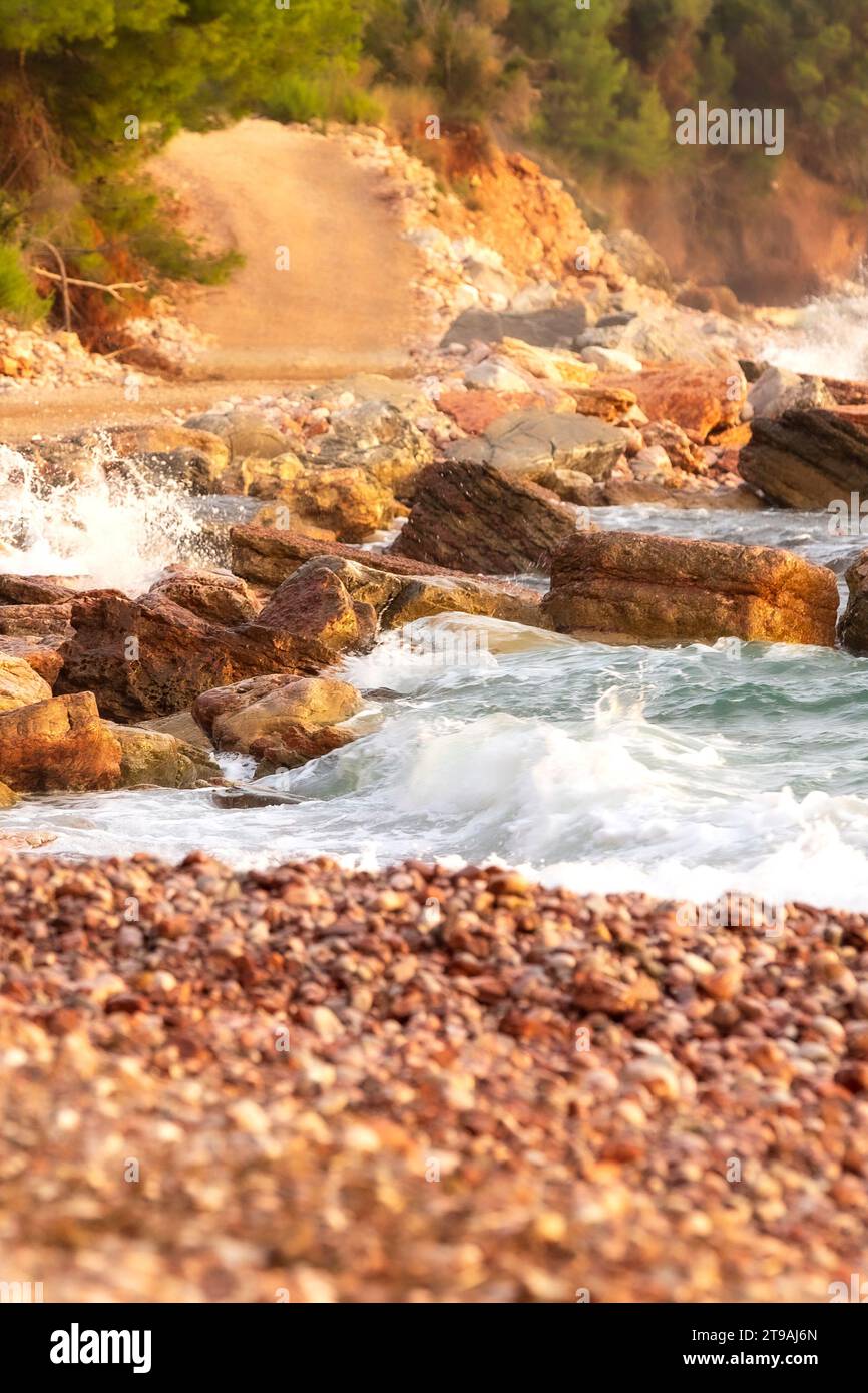 Wild beach Crvena Glavica in Montenegro. Red rocks coast and water ...