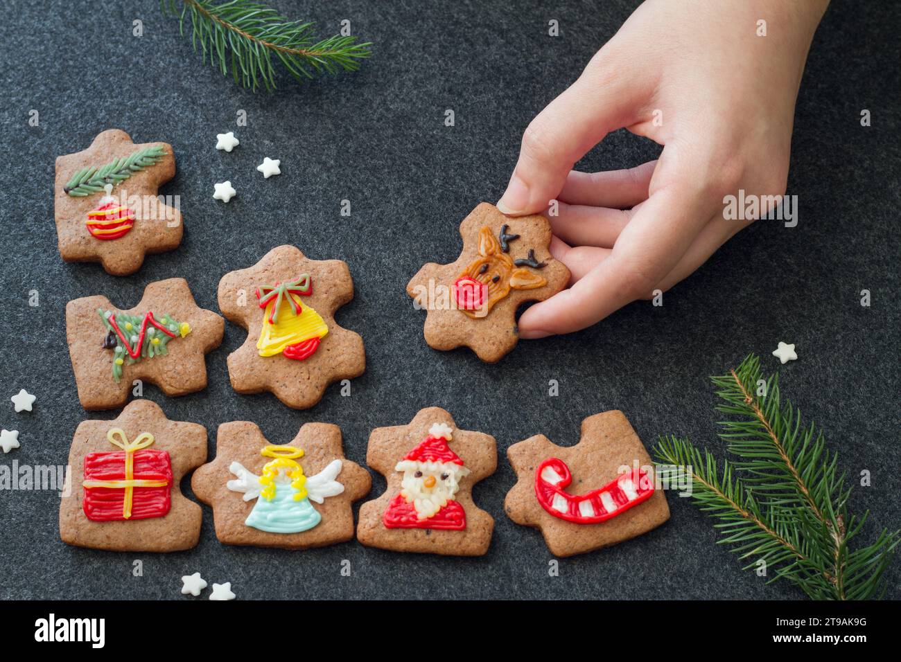 Christmas homemade cookies in shape of puzzle decorated with christmas motifs, elements to form whole christmas, concept Stock Photo
