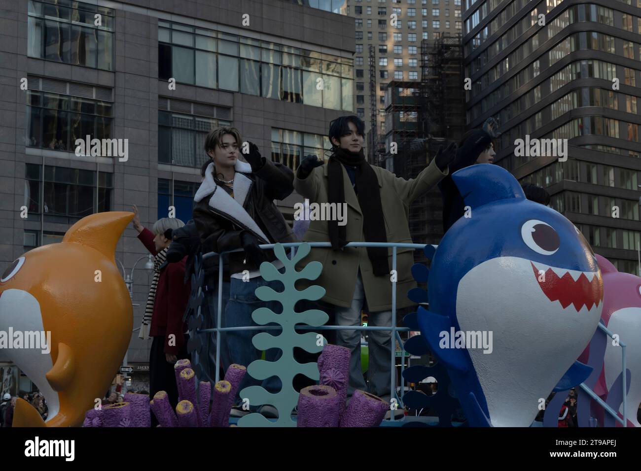 New York, United States. 23rd Nov, 2023. Enhypen band members ride the Baby Shark float during