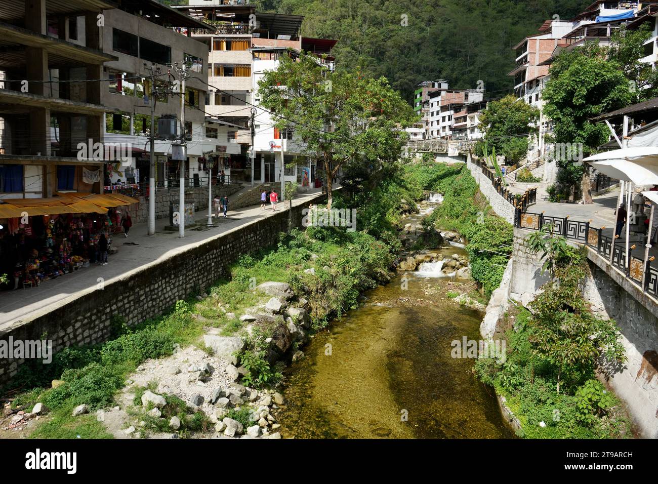 Buildings in the town of Aguas Calientes with the river Urubamba and mountains behind. Aguas Calientes, Peru, October 6, 2023. Stock Photo