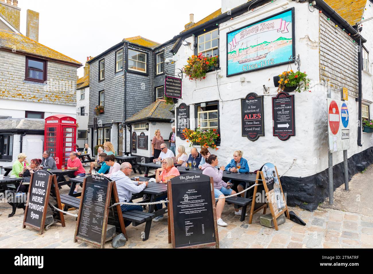 St Ives Cornwall public house the Sloop Inn, people sitting outside enjoying food and drink,Cornwall,England,UK,2023 Stock Photo