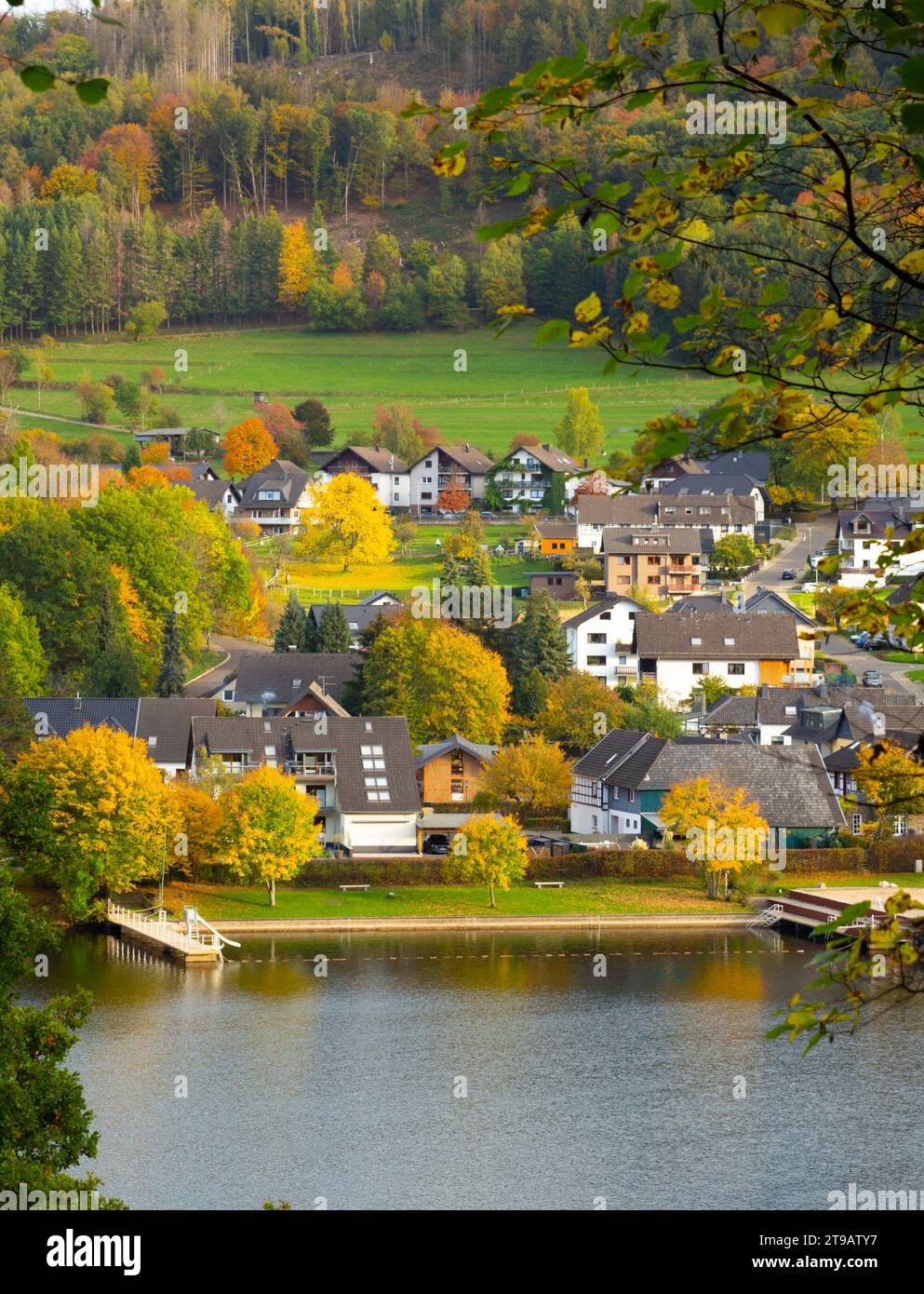 Beautiful german village with colorful foliage forest in the background and reflection in the Rursee lake, Einruhr, Simmerath Stock Photo