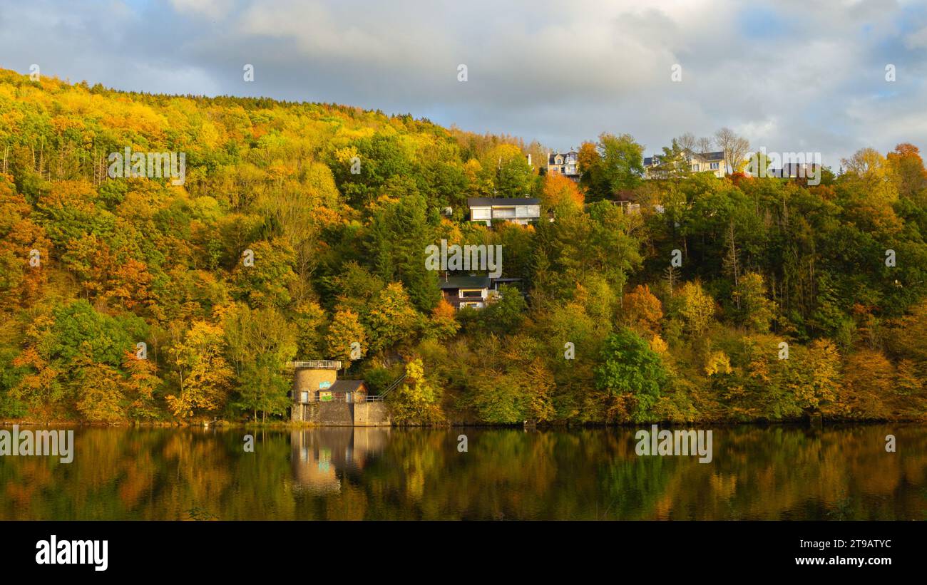 Beautiful german village with colorful foliage forest in the background