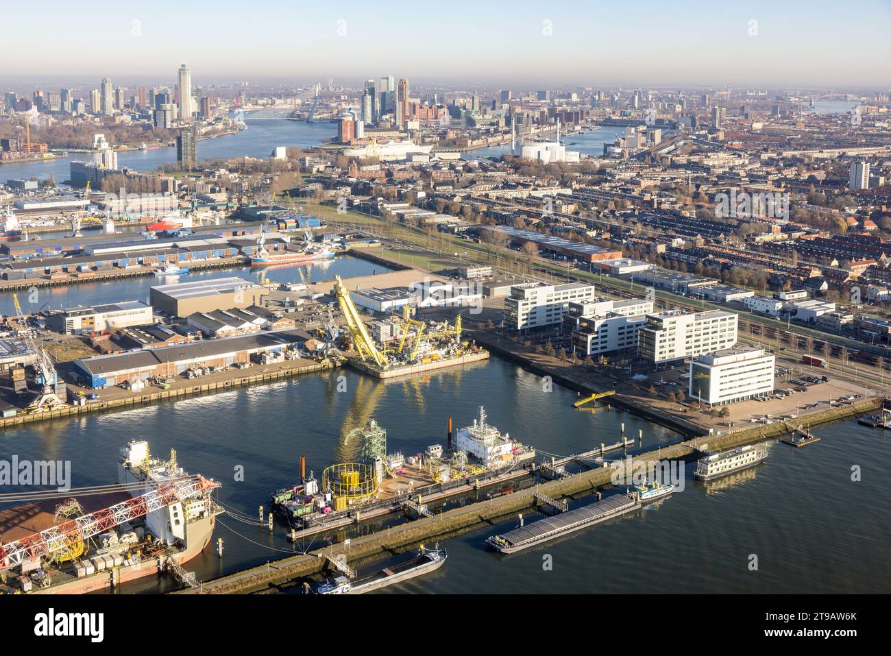 Aerial view Dutch industrial harbor Botlek near Rotterdam with harbors and loading and unloading ships Stock Photo