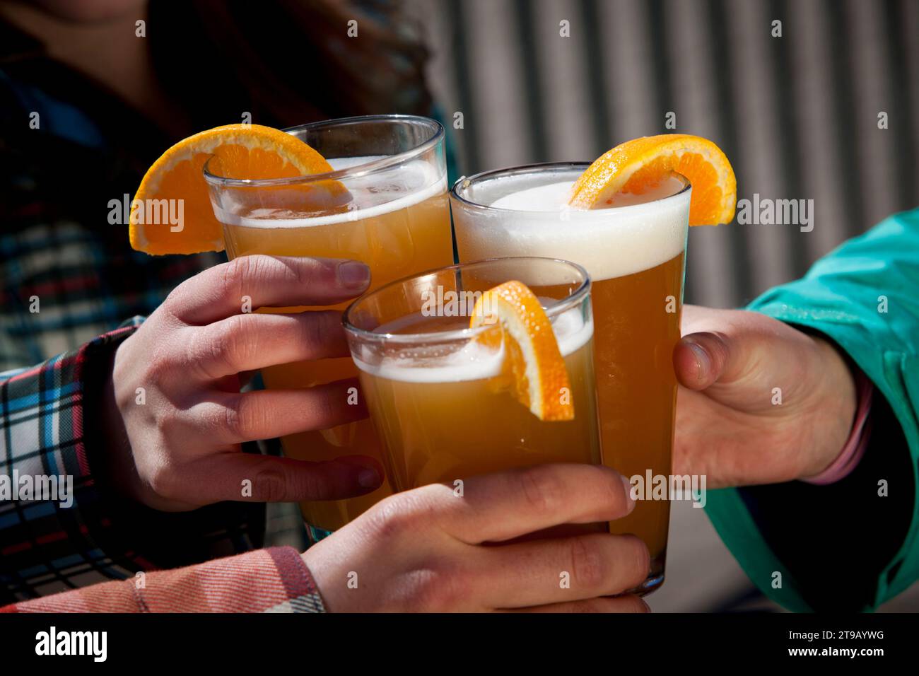 Three pint glasses raised in a cheers. Stock Photo