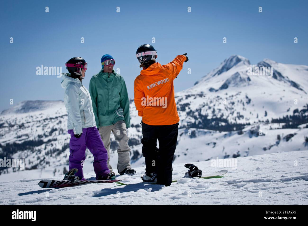 Snowboard instructor giving a lesson at a ski resort. Stock Photo